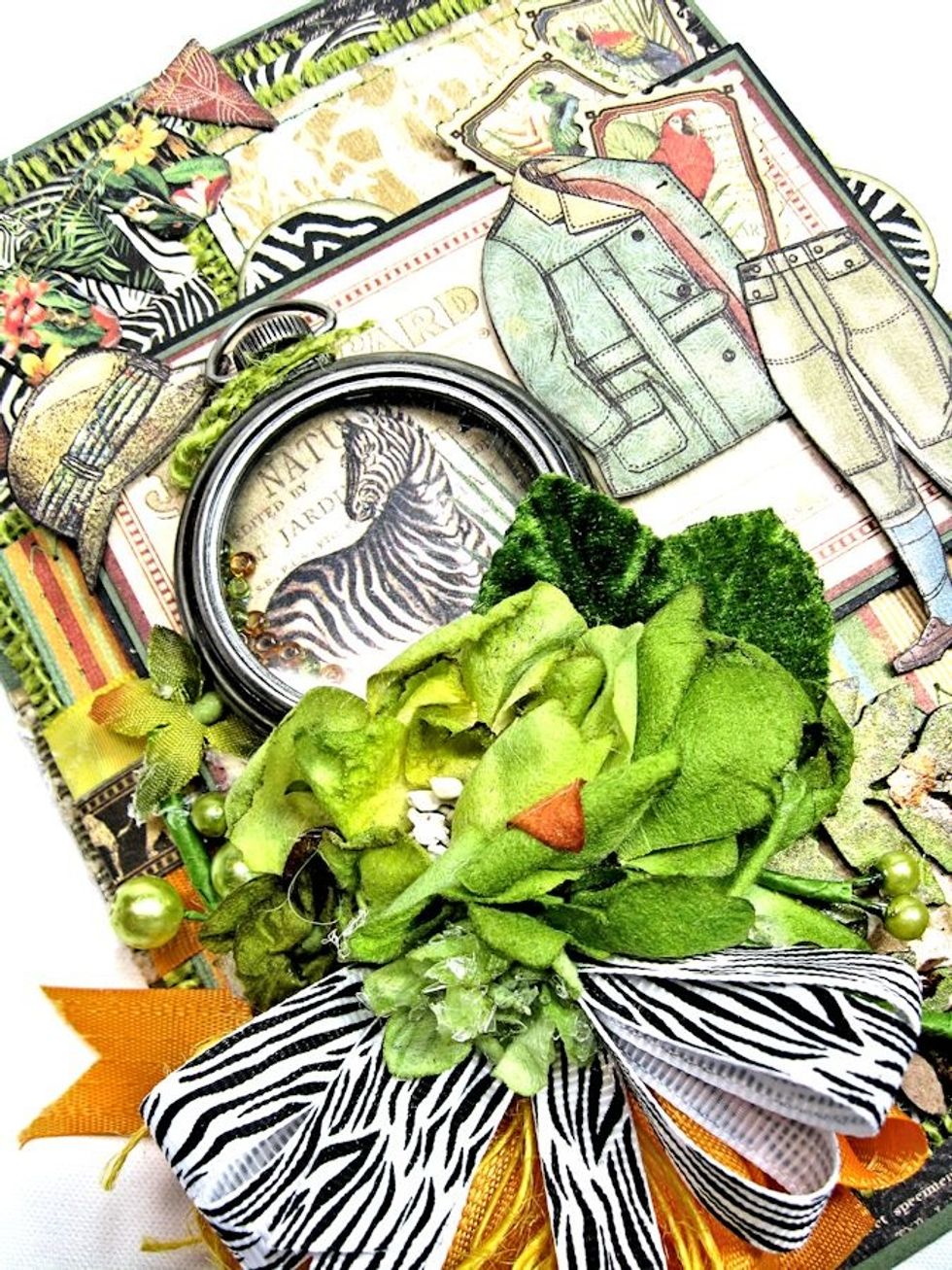 Make Pocket watch: Die cut zebra image from 12x12 Safari Adventure Border. Die cut acrylic circle to fit inside frame. Glue image to bottom. Attach acrylic with Glossy Accents. Add seed beads.