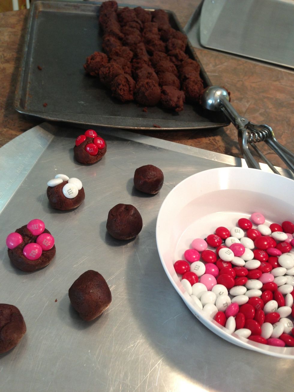 Make regular size cookies with the rest of dough. Roll each portion into smooth balls. Top with M&M's. Bake 350\u00b0 8-9 minutes.