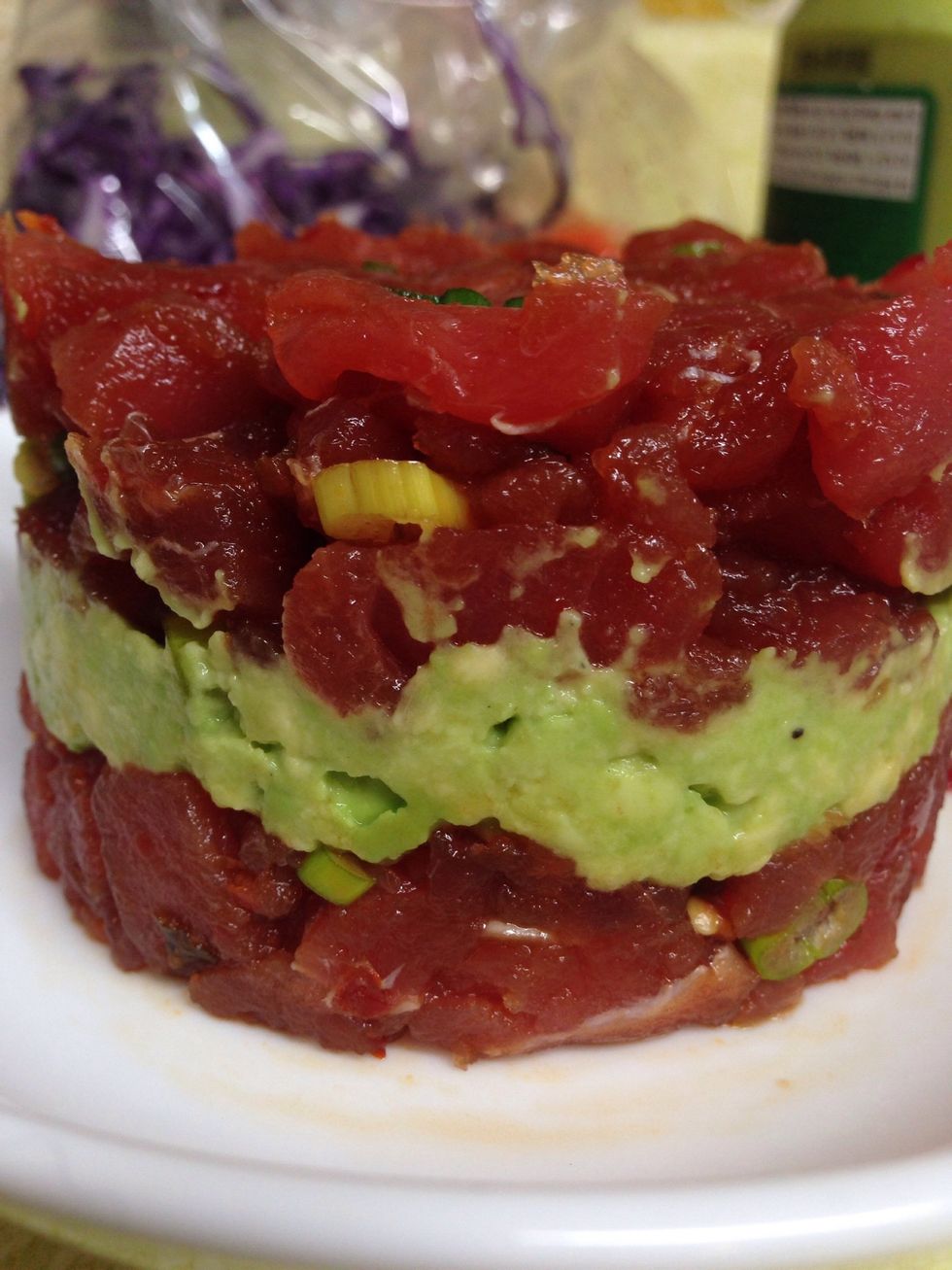 Make sauce for tuna (1/2 cup soy sauce; tablespoon of sesame oil; 2-3 tablespoons of seasoned rice vinegar) Chop tuna add sauce and green onions (mix together). Mash Avocado; Layer tuna and avacado