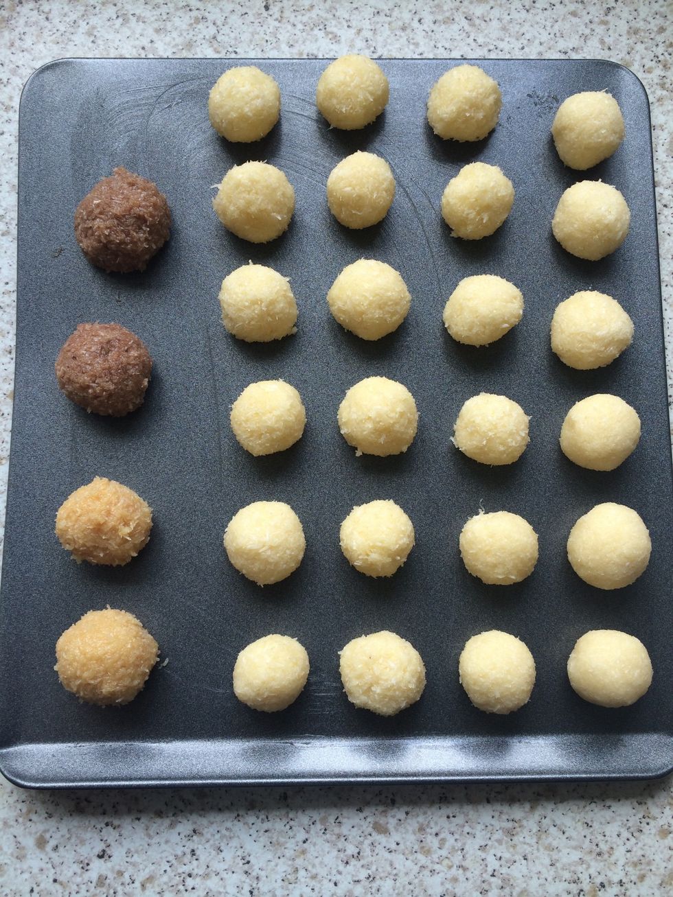 Make small balls with the mixture and place on a lined/greased baking tray. The two on the bottom left have a teaspoon of peanut butter added and the two darker ones have chocolate hazelnut spread.