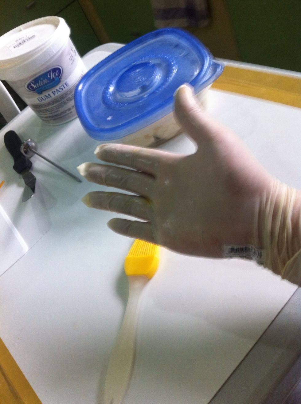 Make sure before you knead your gum paste wear ur Surgical Gloves and spread shortening into it, into your palm & in bet. fingers. This will help u alot.