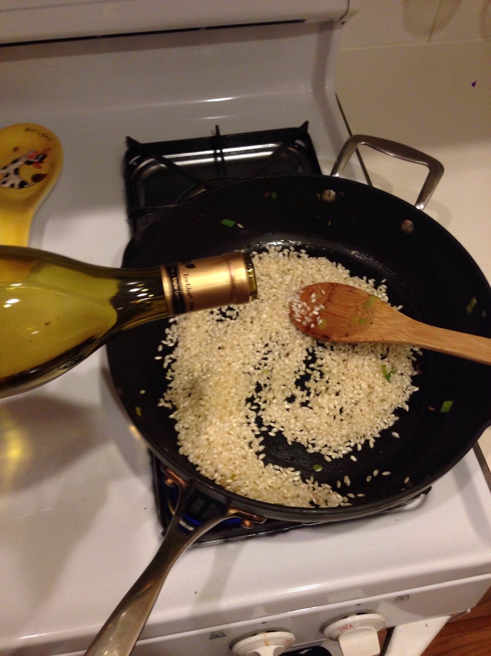Make sure heat is on medium. Add about 1/4 cup of white wine. Stir!
