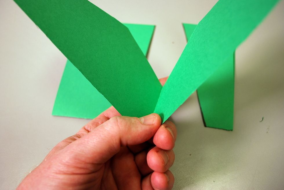 Make sure not to cut through the paper fold connecting the two wing parts or the sides of the tail.