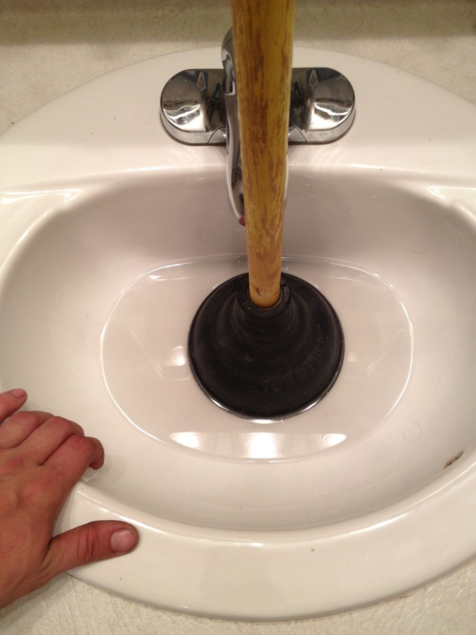 Make sure that at least 2 inches of the plunger is submerged in water and that the sinks overflow hole is sealed. If air is still getting in, hold the tp plug in the overflow hole while plunging.