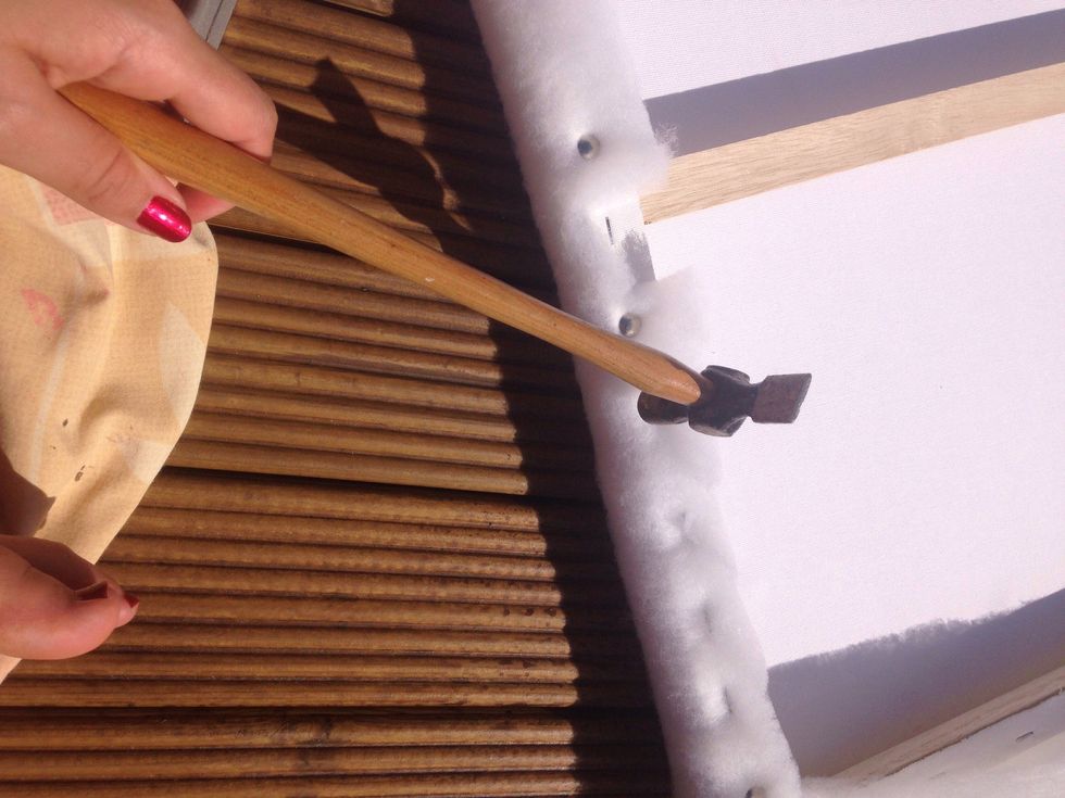 Make sure the batting is secure by hammering in each staple.