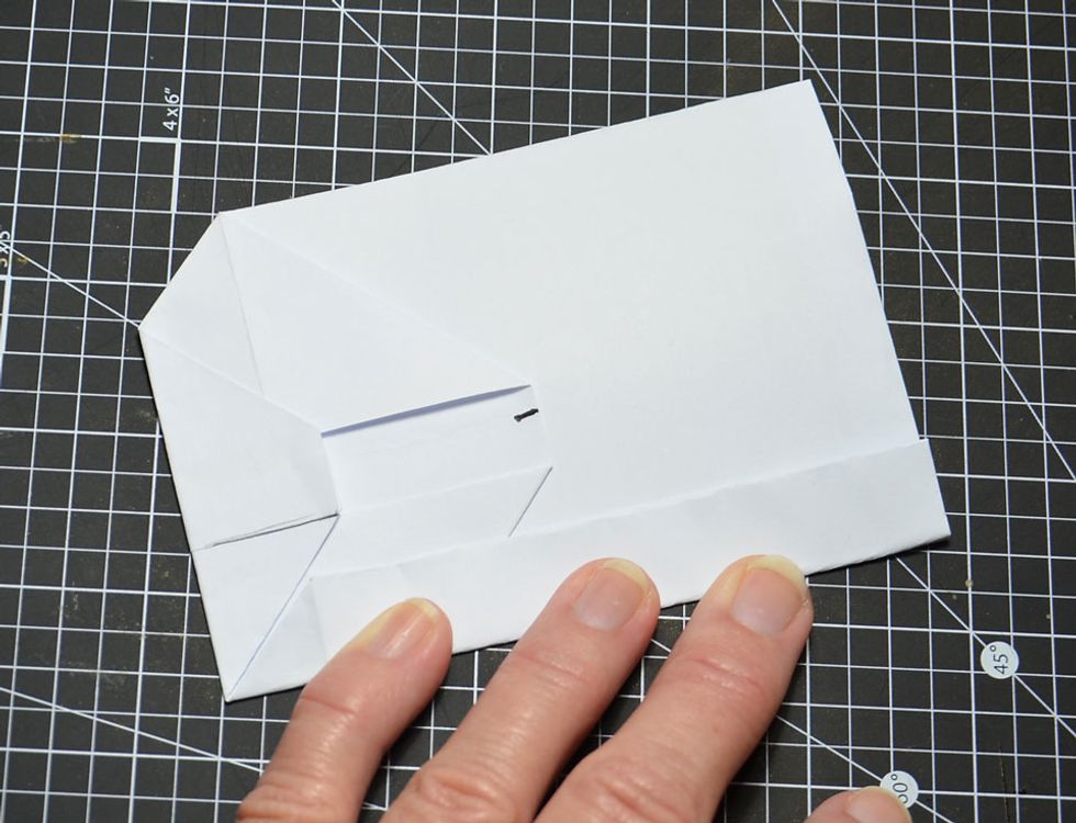 Make sure the bottom of the fold lines up to fit nicely with the already folded piece on the bottom as shown.
