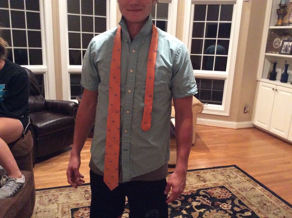 Make sure the fatter end is on the right and then wrap the tie around your neck