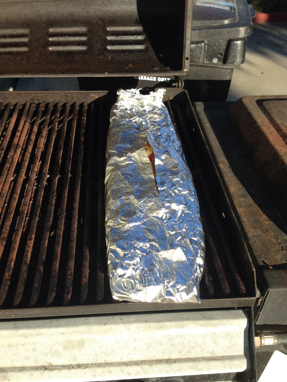 Make sure the grill is cleaned off and add the potatoes to the grill to cook. Turn the heat down to medium.