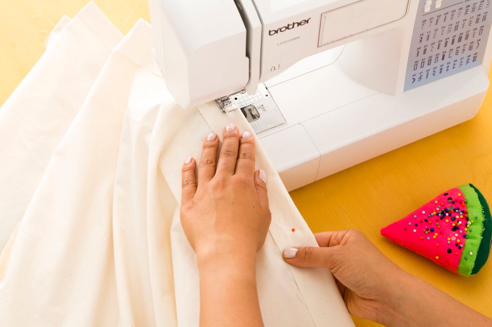 Make sure the hem line for both the muslin fabric and the printed fabric are pointed the same way.  Sew along the edges where you pinned.