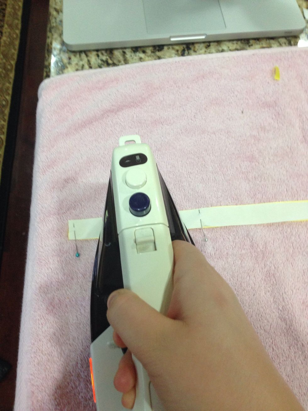 Make sure the iron is set to medium. You can use pins to hold the ribbon in place as you fuse the ribbon with heat n bond. Do this process until you have fused all the ribbon.