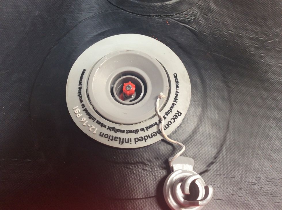 Make sure the red nipple is in the up position. This closes the valve so you can now pump up your board. To close, depress and turn the nipple a quarter turn in either direction until it pops up.