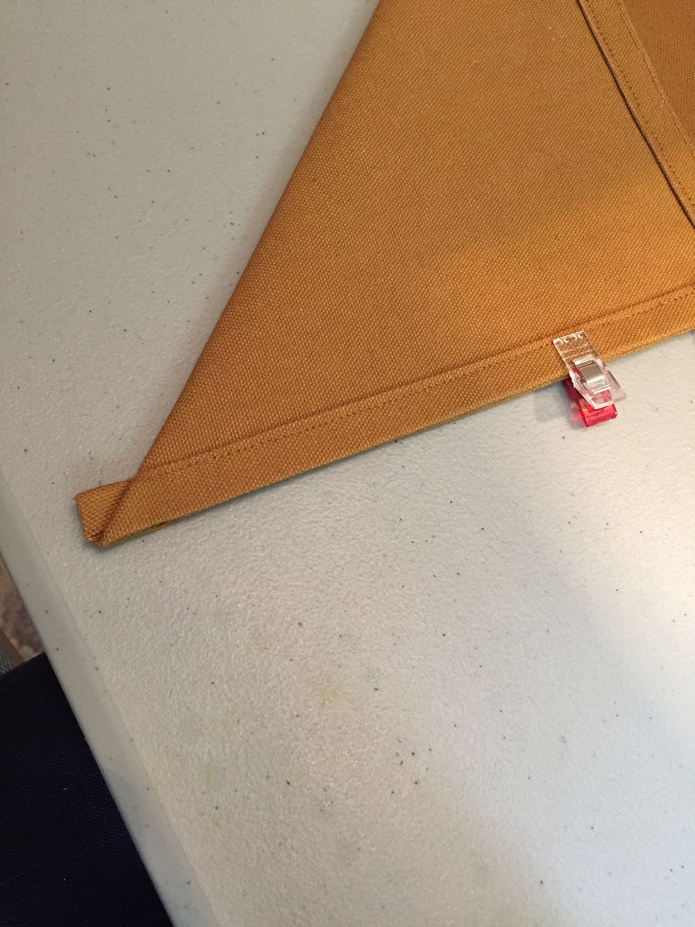 Make sure the right sides are facing each other and the edges are lined up exactly, with a good point at the corner. Press as needed.