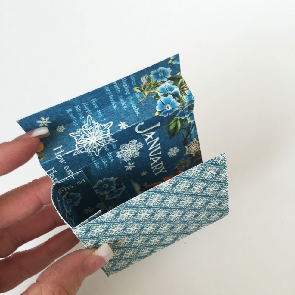 Make sure to have the three \u00bd\u201d segments on the gift bag sides piece on your left and glue each  \u00bd\u201d side flap of the Gift Bag Bottom to the bottom of the Gift Bag Sides piece\u2019s 2 \u00bc\u201d segments.