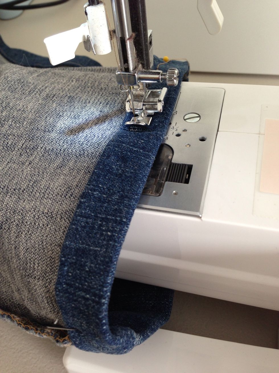 Make sure you don't sew the leg closed. Using zipper foot helps keep even pressure while guiding the hem better. I use all purpose thread instead of buying thread for denim.