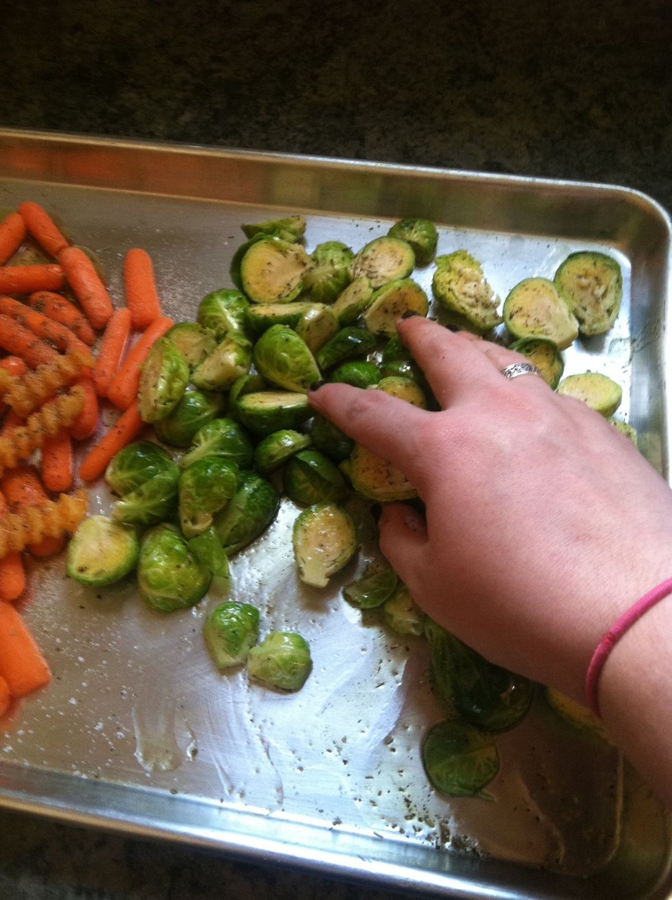 Make sure you have clean hands, and toss the veggies with all the seasonings and olive oil using your hands! Make sure to keep the sprouts to one side!