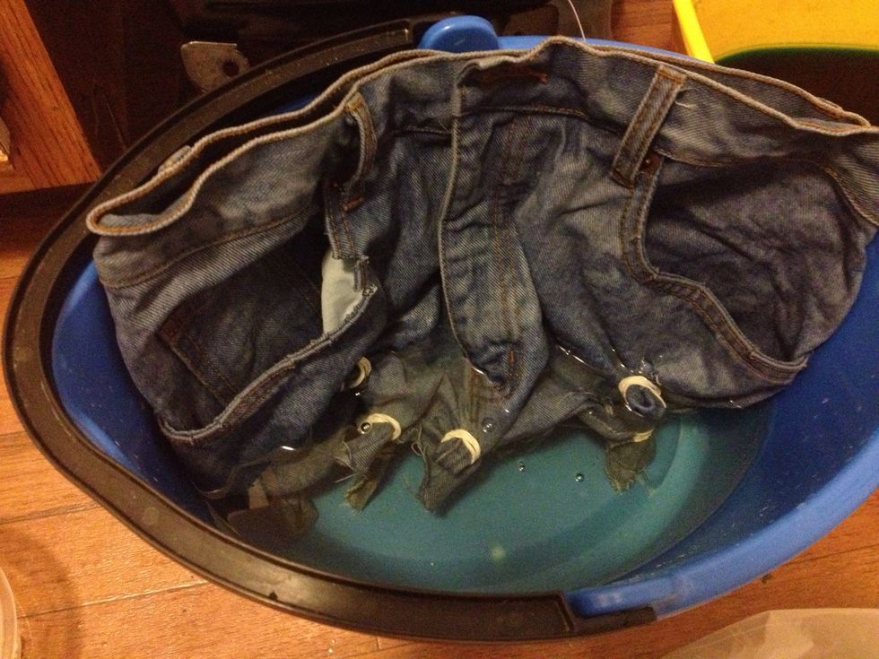 Make sure you pre-rinse the jeans. You will also need to use a bucket to make a 2 parts water/1 part bleach mixture. Then, put just the bottom of the jeans in the bleach mixture. Give them 30 minutes.