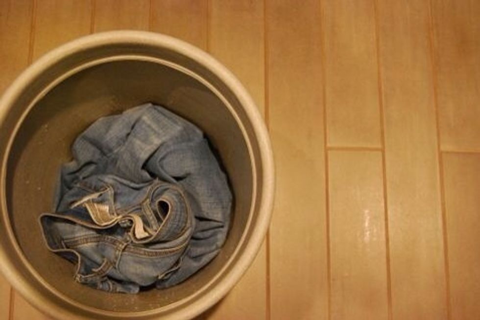 Make sure your Jeans are washed and dried. Put them in your Bucket you don't mind ruining or a stainless steel sink.
