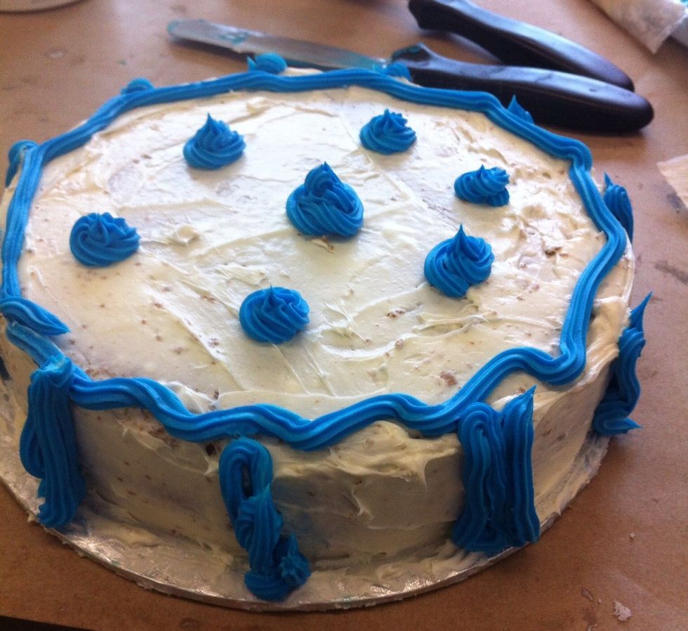 Make swirly stars in various spots on top of cake. Then add some stripes on the sides. Voila, you have simple tasty decorated cake