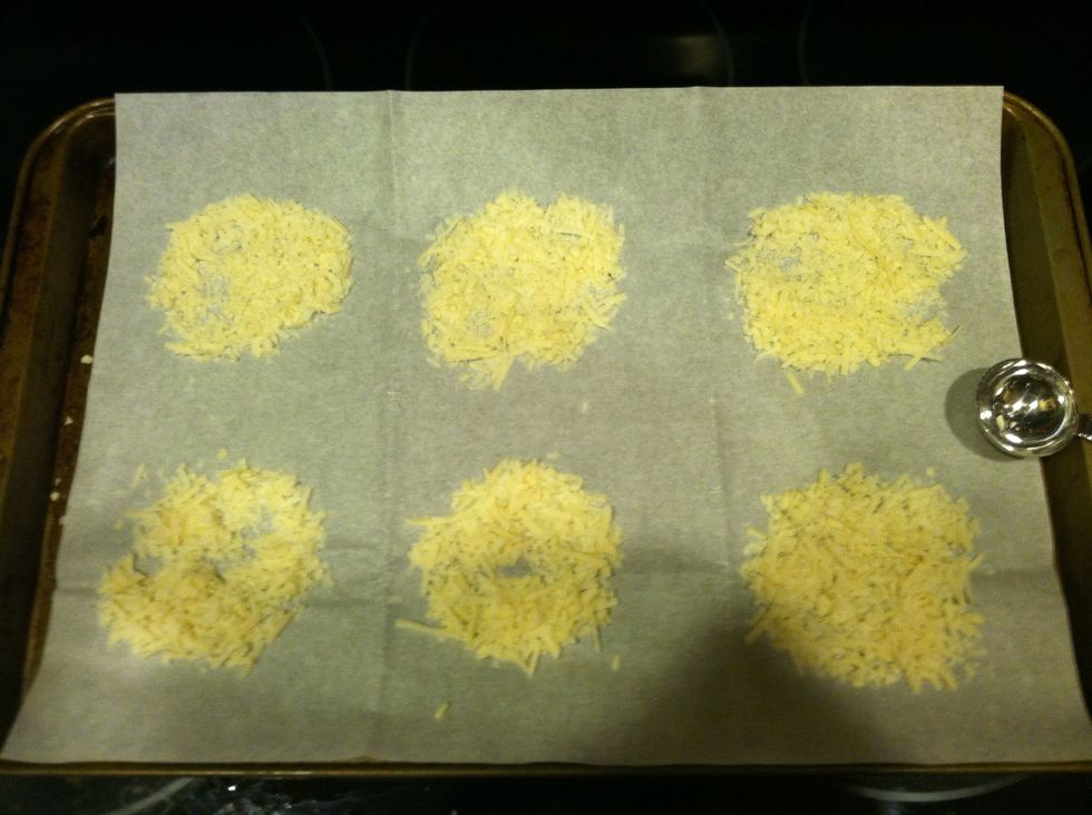 Make tablespoon mounds of the shredded cheese. Spread the cheese out so its nice and flat so it will melt nicely when in the oven.