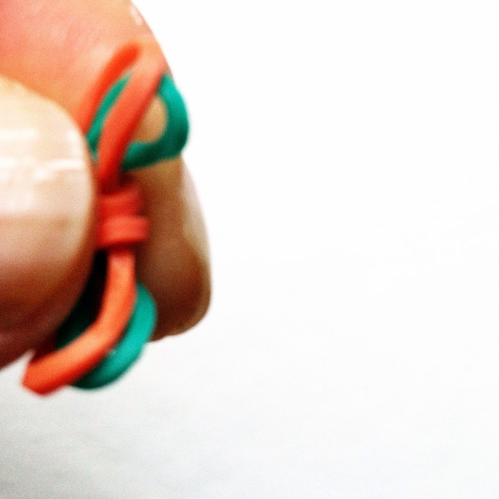 Make the bracelet as long as desired, hold the end of the bracelet with your fingers and pull off the pens. I like to remove one elastic before attaching the clamp that is provided with the elastics.