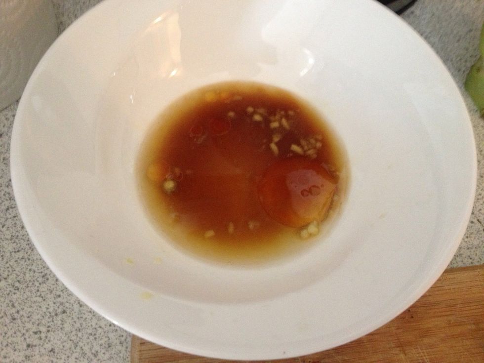 Make the dressing by taking 1/2 tsp crushed ginger, 2 tsp soy sauce, 1/2 tsp sesame oil, juice of 1/2 lime and mixing well