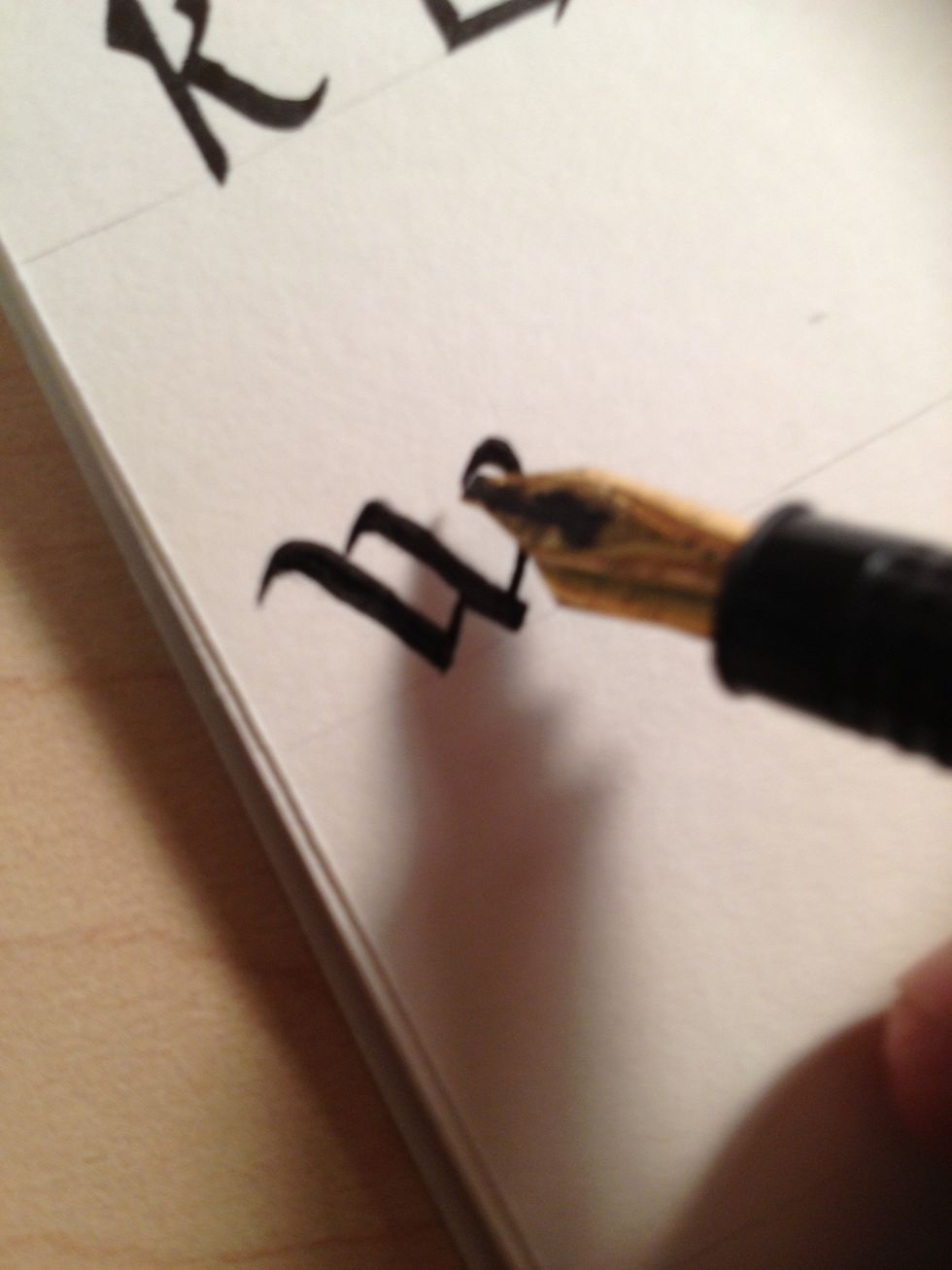 Make the final stroke begun slightly above the base of the third stroke. Note how it curves back on itself in an exaggerated flourish.