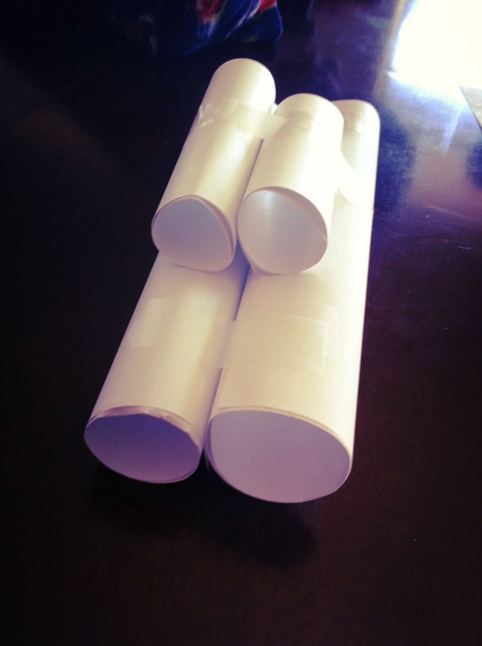 Make the frame of your paper car. Cut two sheets of paper, one part smaller than the other. Roll all pieces & tape together, top pieces are the small ones. You can also use paper towel & TP rolls.