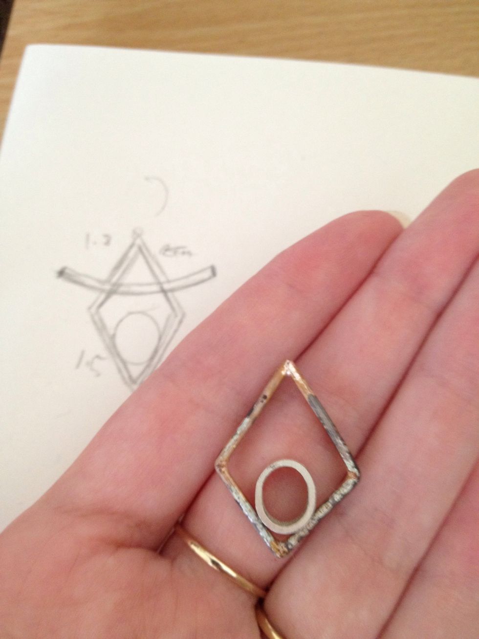 Make the general shape of the body of your pendant by filing away inside sections of the straight D shaped wire. The depth of the filing depends on the degree of the angle you desire.