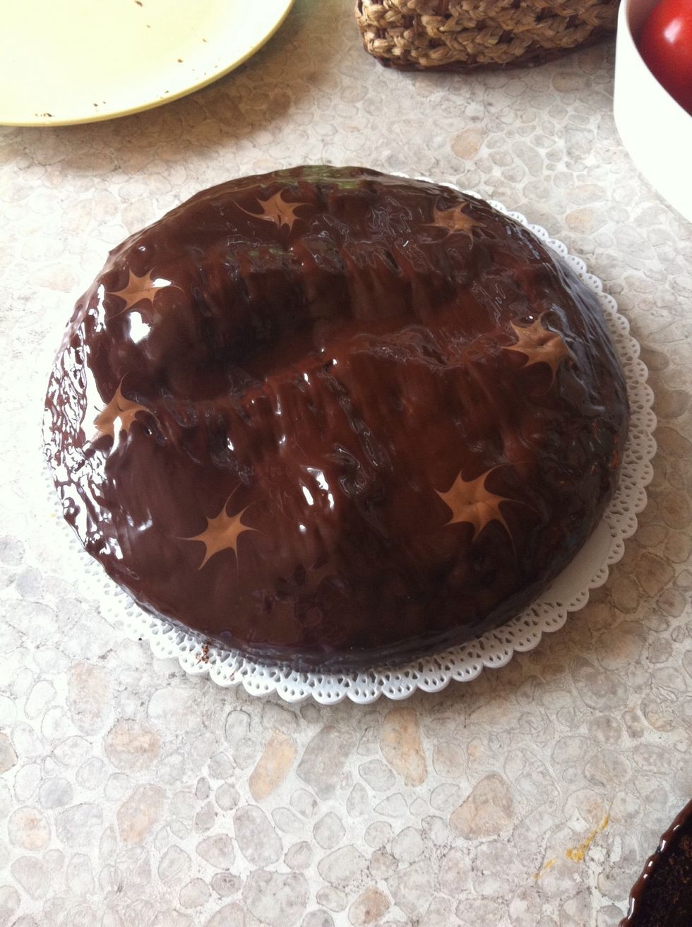 Make the icing by breaking the dark chocolate into pieces (70% cocoa recommended). Them pour the icing on the centre of the cake. Spread it gently over the top and down the sides, and leave to set.