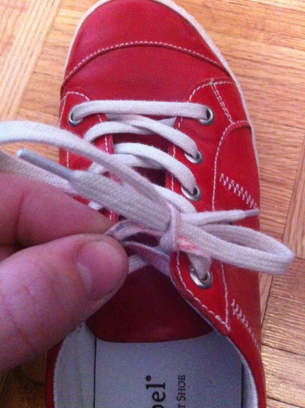 Make the loose end lace into a loop and pull it through to make your bow :)