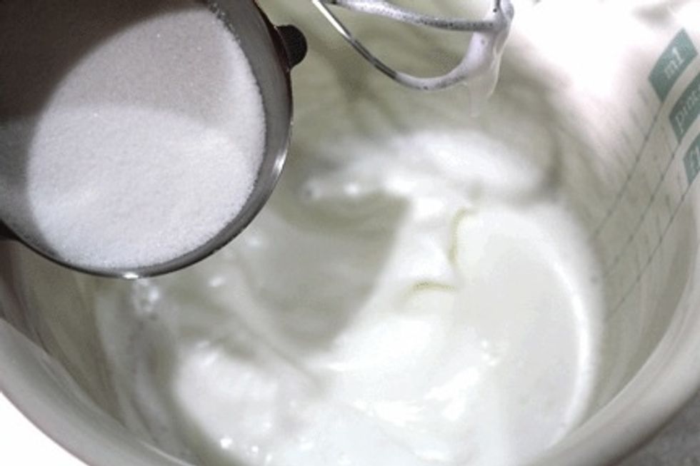 Make the meringue by gradually adding granulated sugar while mixing the ingredients. Continue mixing until mixture is semi-firm.