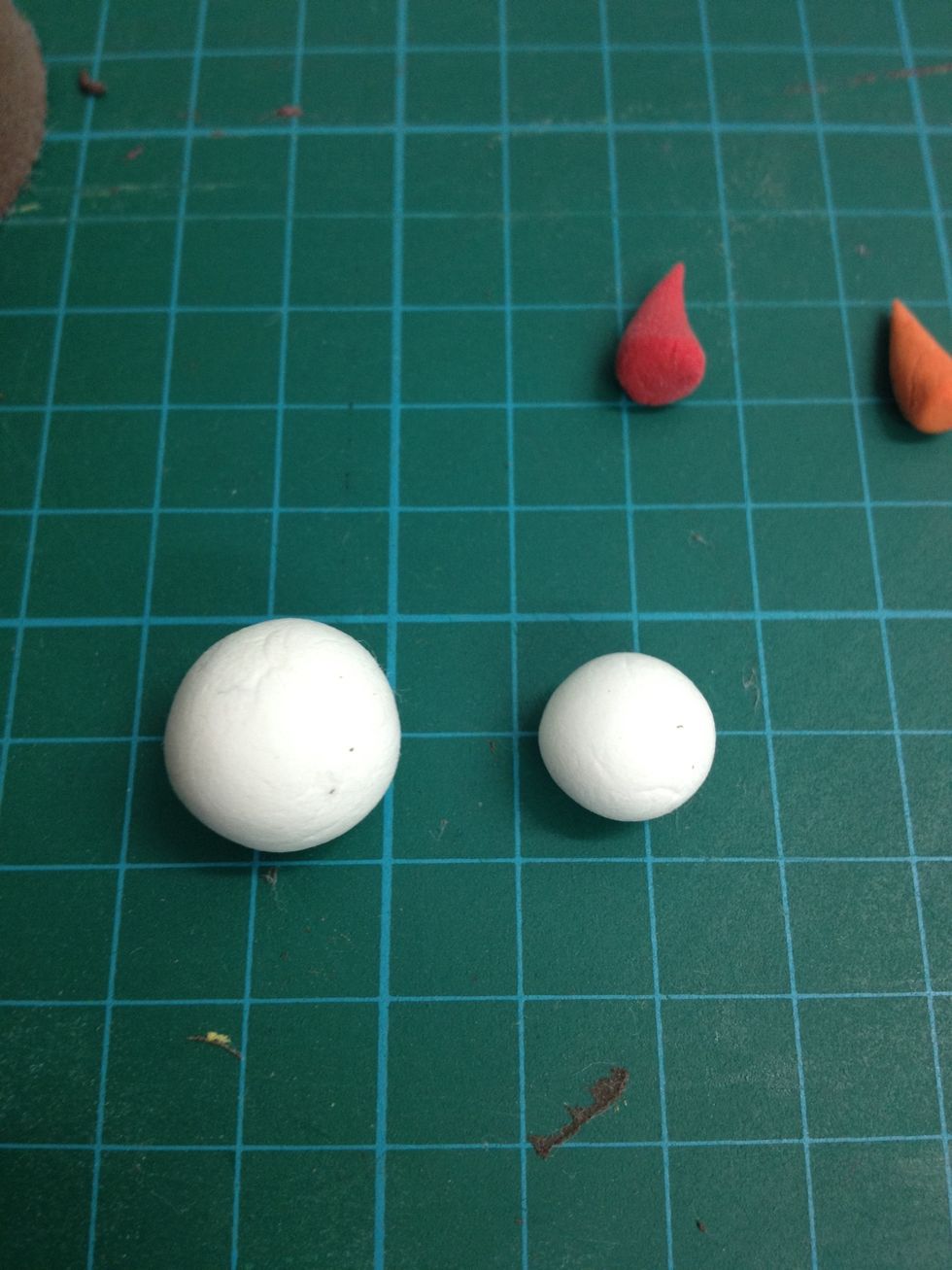 Make the orange clay into another cone to make it as the snowman nose. Then, Make 2 white balls as the head and body of the snowman.