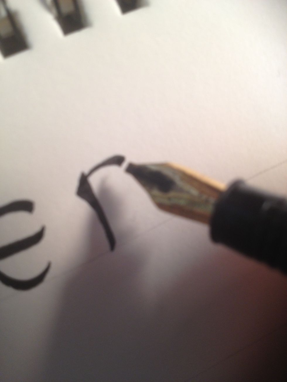 Make the top bar curved, terminating when the line is at it's thickest; attention to nib angle is important here.