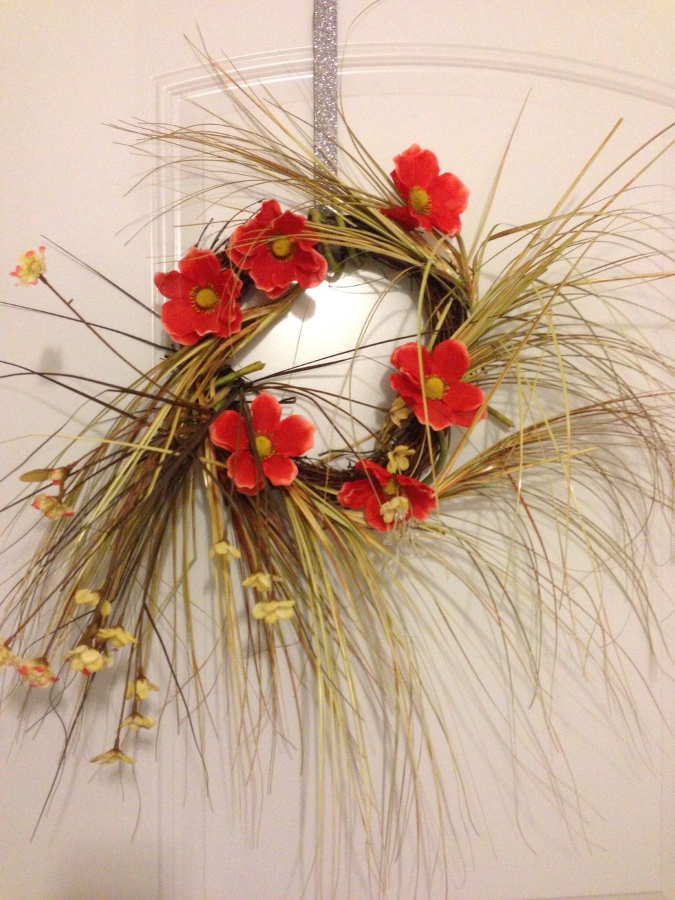 Make this wreath by inserting the artificial flower wire stems inside the openings of the wreath. Twist as desired. You can buy the flowers from your local dollar store. Now, sit, enjoy and relax!