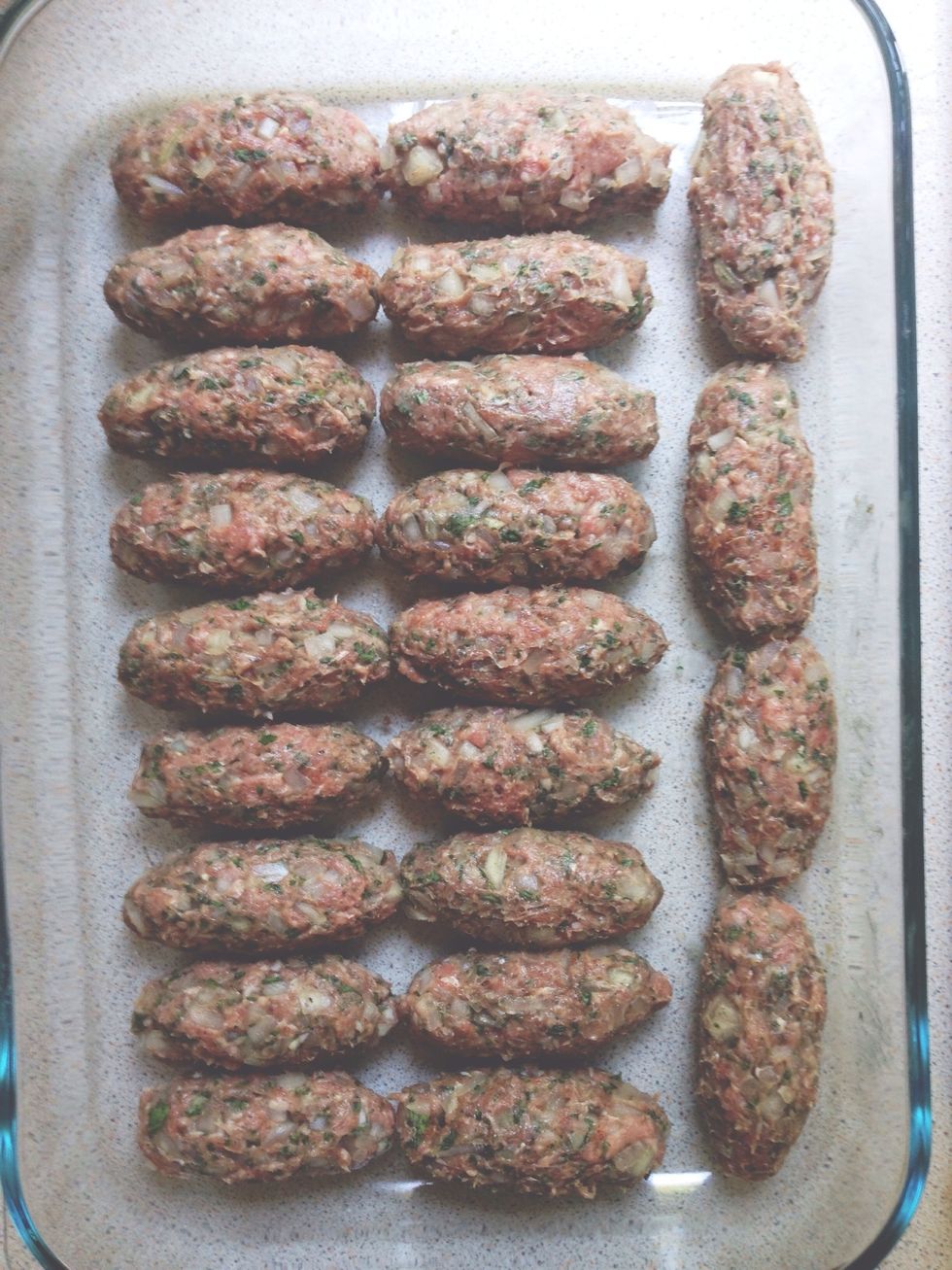 Make three-inch rolls of the lamb mixture and place side by side in a baking dish. Place them in a a preheated oven set to 350 F (180 C) and let bake.