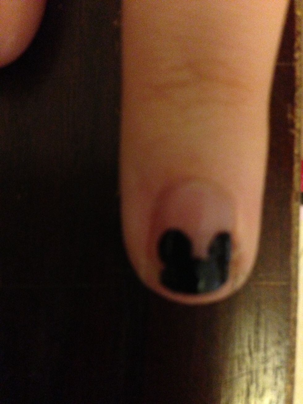 Make three large black circles to create Minnie's head on your ring fingers.