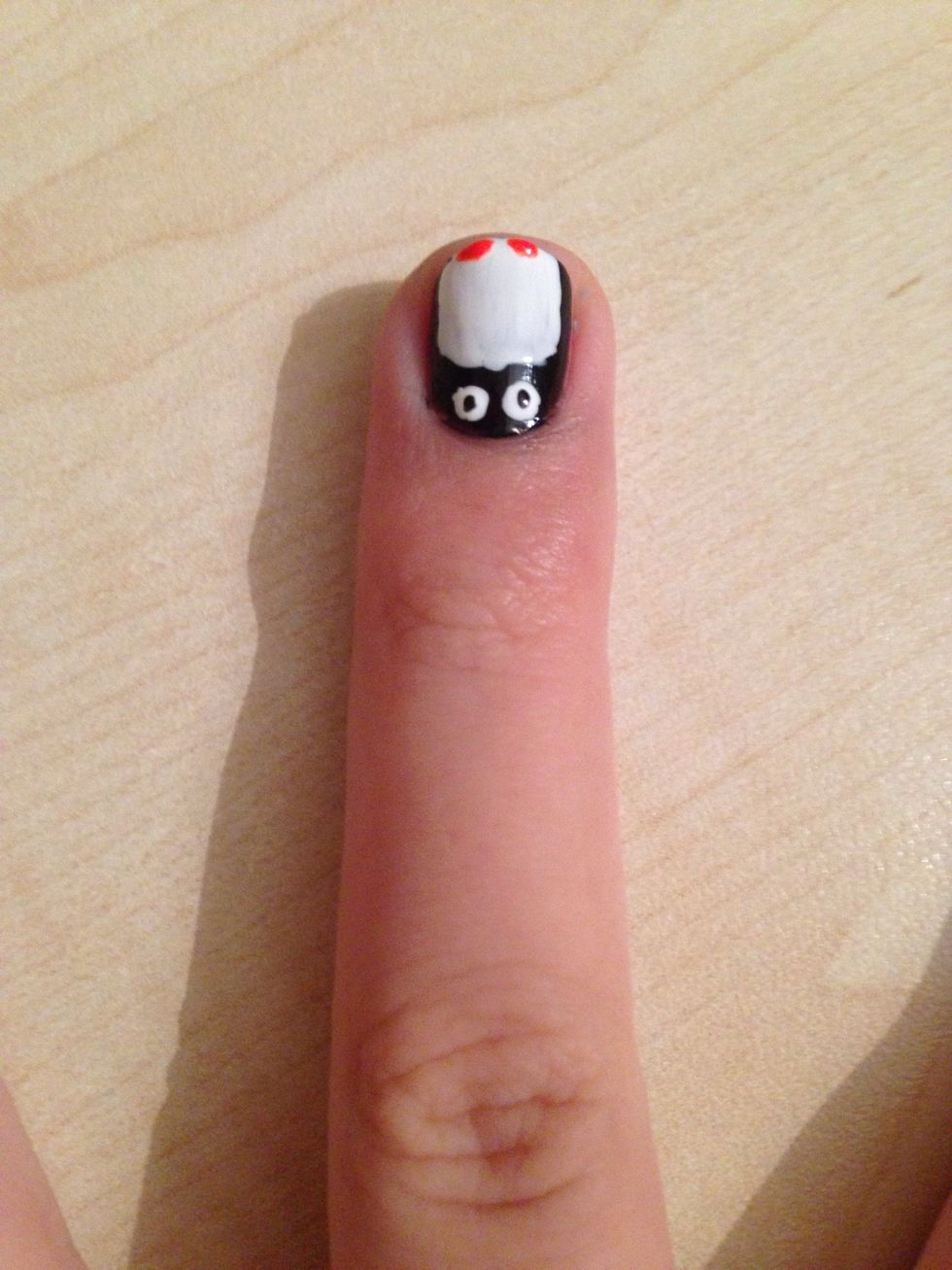 Make two dots with the orange nailpolish under the white part, these are gonna be your penguin's feet