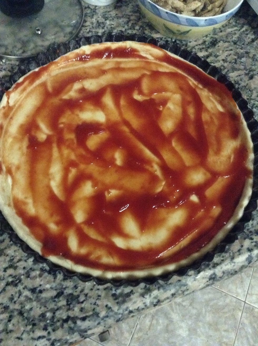 Make two large balls from the dough and roll them and spread in the baking dish, and then spread the tomato paste or tomato ketchup