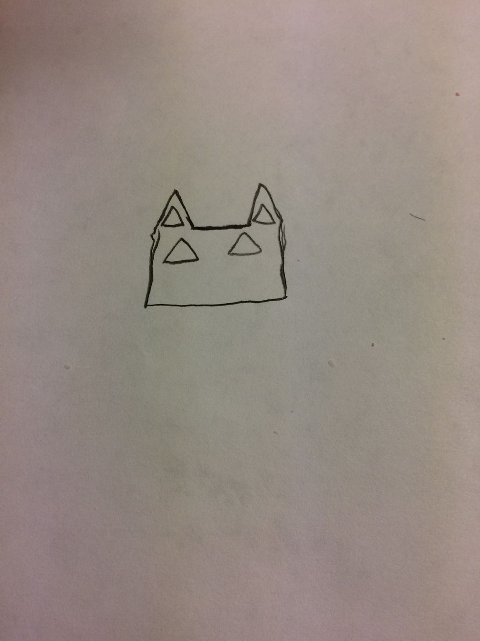 Make two medium size triangles in the center of the fox