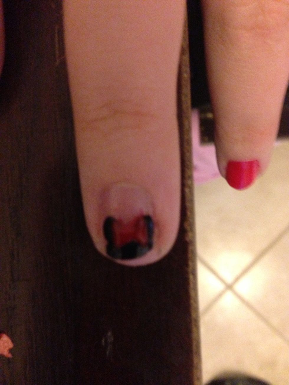 Make two red triangles for her bow.