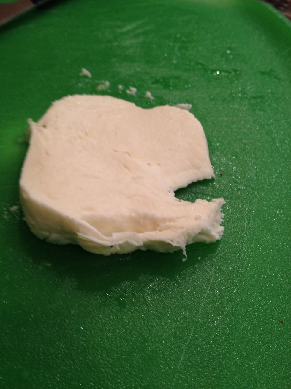 Make two slices of mozzarella and place on top of the tomato.