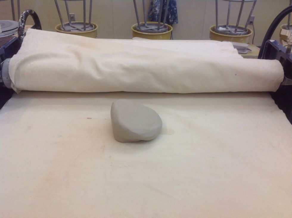 Make your ball of clay into a wedge shape.