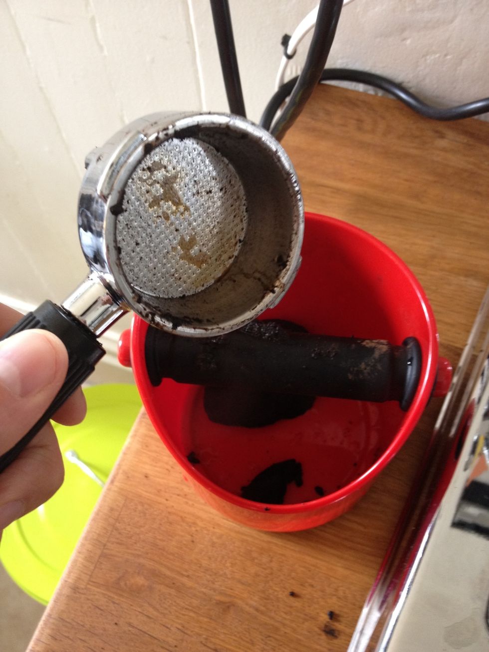 Making espresso makes a mess. Don't skip the cleanup. Empty your puck to the compost or a handy tamp box like this. No need to wash the basket before the next cup. Remember, a hot filter works best.