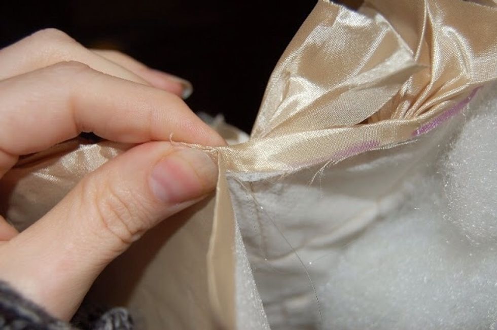 Making sure to pinch it tight.. You may use fabric adhesive if you don't want o use hot glue just follow the instructions given.