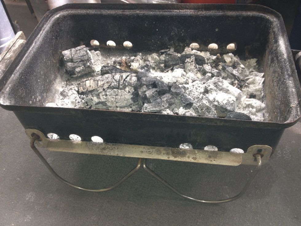 "Mangal" -a traditional kabab grill is shallow  <6" and flat bottomed for even cooking. I use a Weber Go anywhere grill and remove both grates. 24" skewers sit perfectly across this grill.