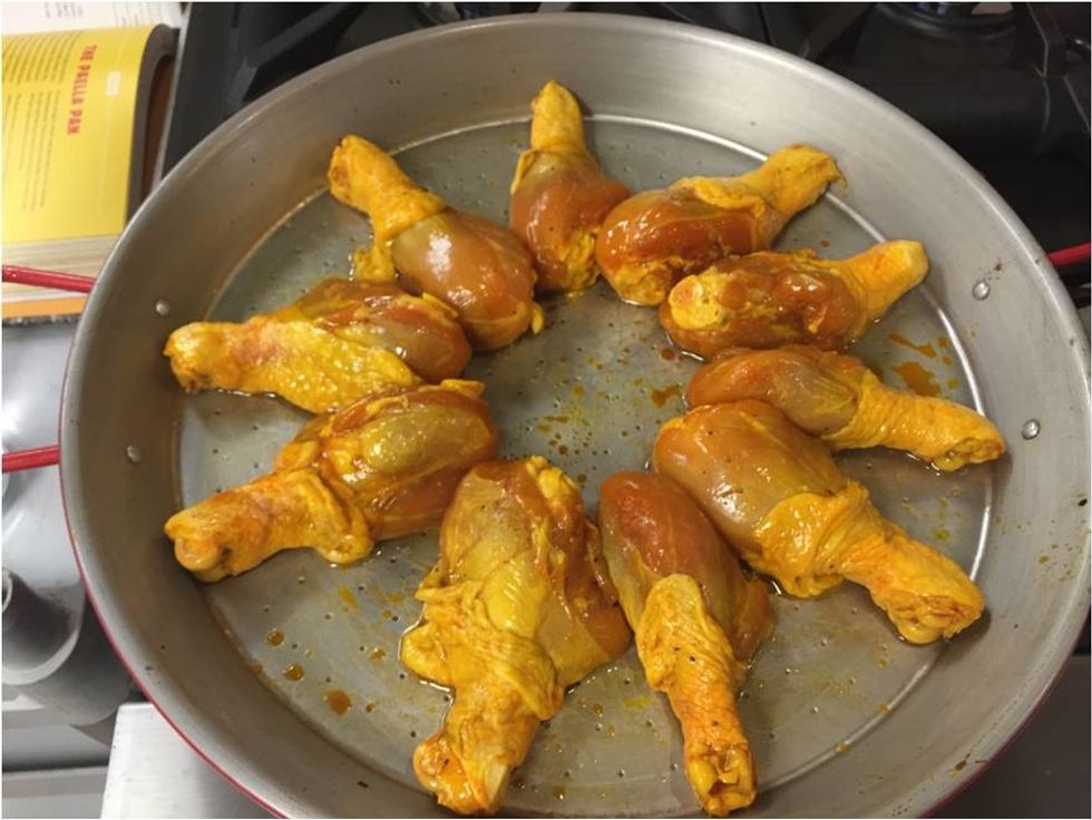 Marinate the chicken with the Paella mix & salt/pepper. Place marinated chicken into a Paella pan with the onions and rice.