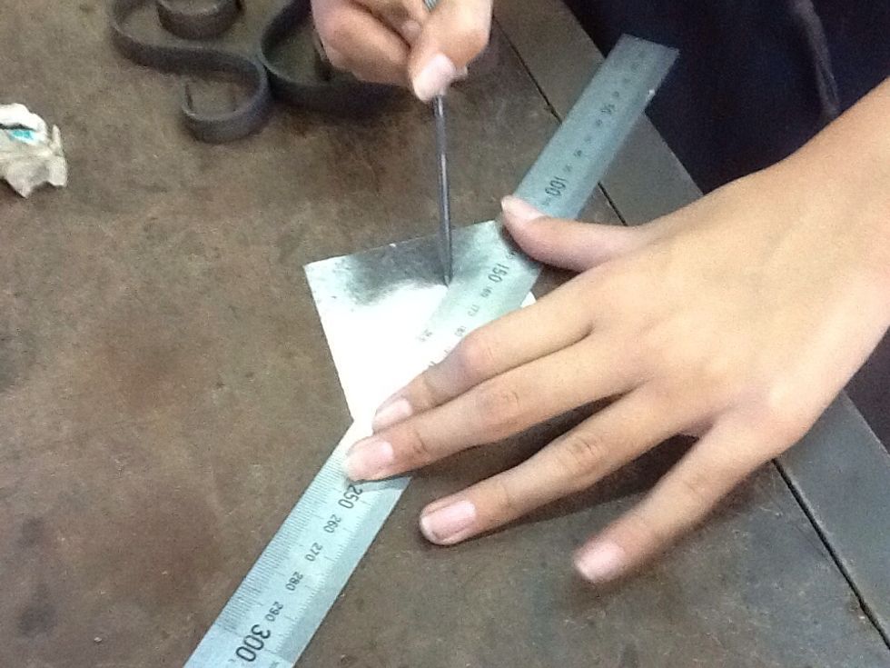 Mark a cross into the metal so you can find the centre