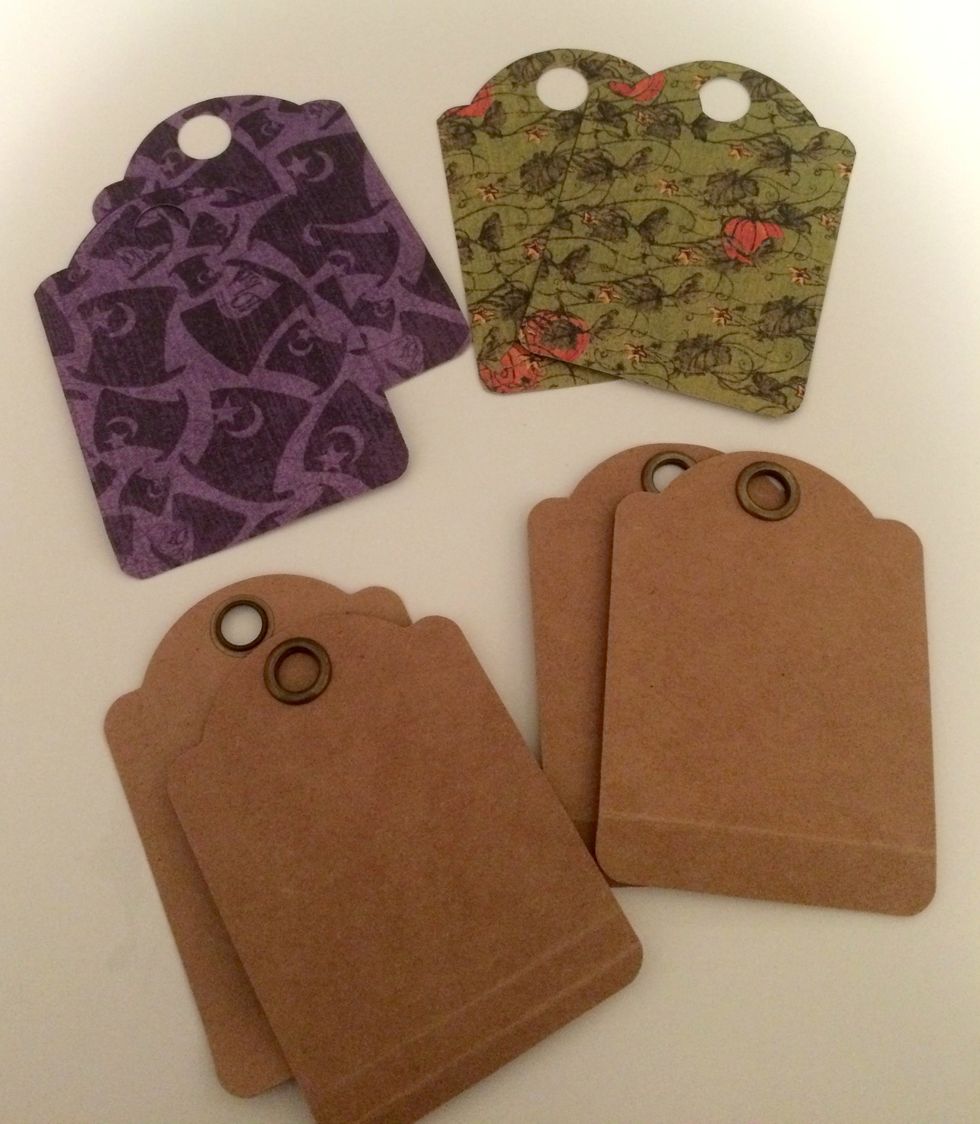 Mark on your patterned paper cut out tags where the eyelets is on the kraft ATC tags. With a 1/2" circle punch, punch a hole in the top of the patterned paper tags.