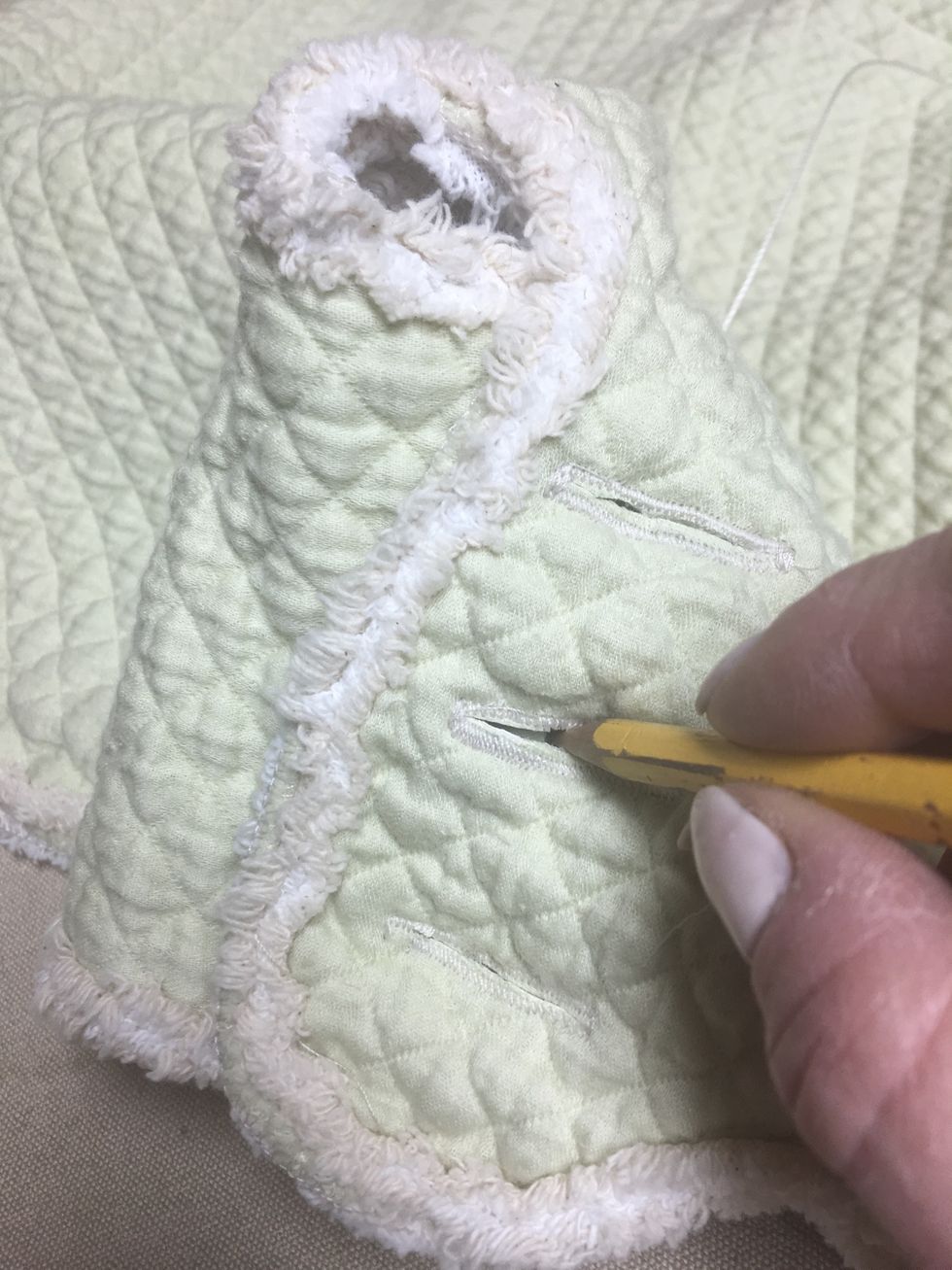 Mark the button placement through the buttonholes on both sides of the back flaps