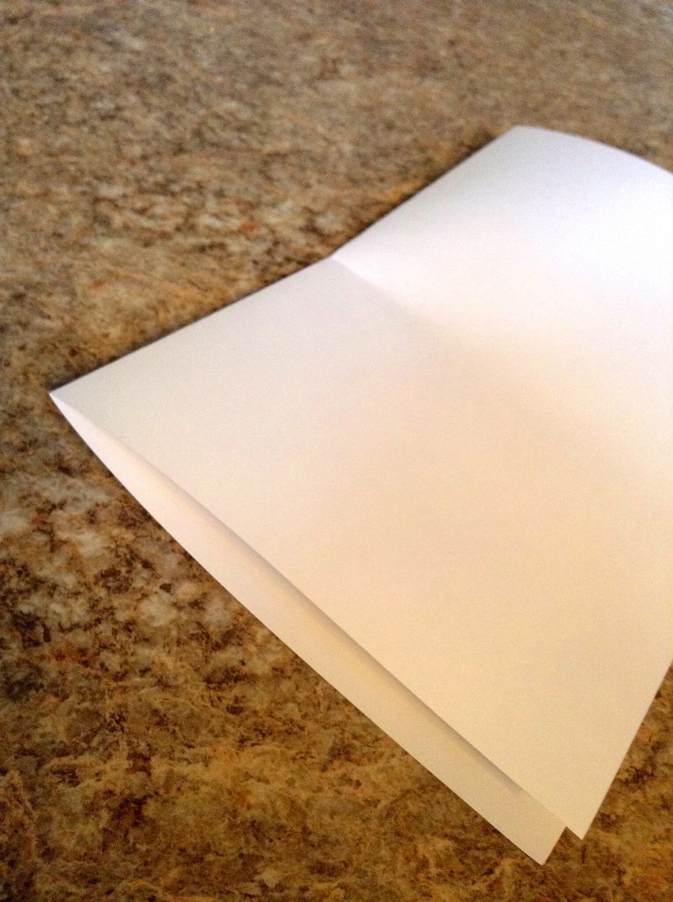 Mark the halfway point on the paper with a small crease.